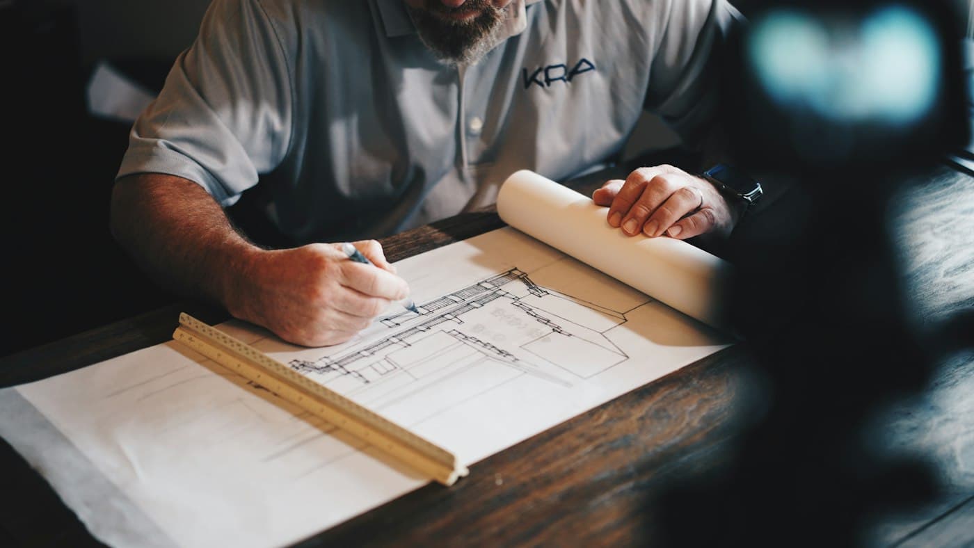Architectural renovation plans on a timber table